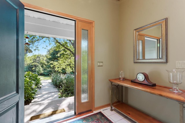 doorway with light tile patterned floors and a wealth of natural light