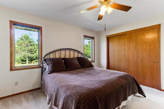 carpeted bedroom with a closet and ceiling fan