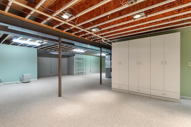 basement featuring heating unit and carpet floors