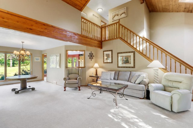 living room featuring a notable chandelier, high vaulted ceiling, and carpet flooring