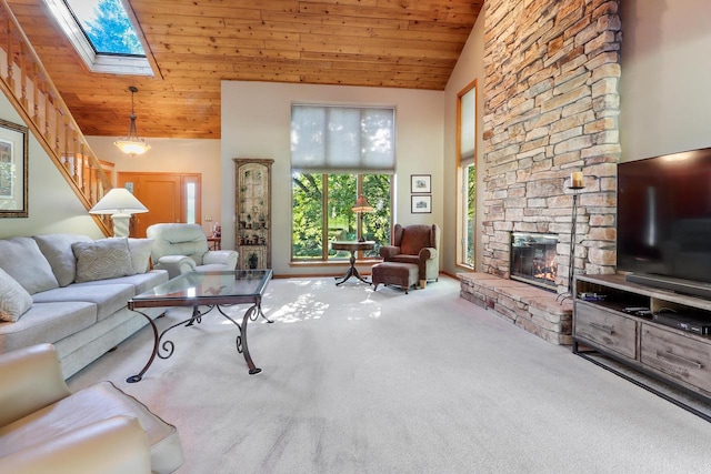 living room with a skylight, high vaulted ceiling, wooden ceiling, and carpet