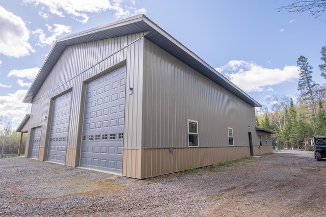 view of property exterior featuring an outdoor structure and a garage