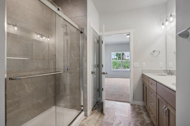 bathroom featuring vanity and a shower with door