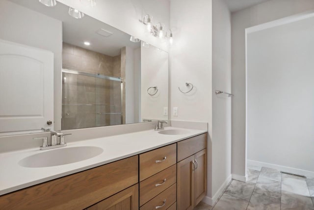 bathroom with vanity and a shower with shower door