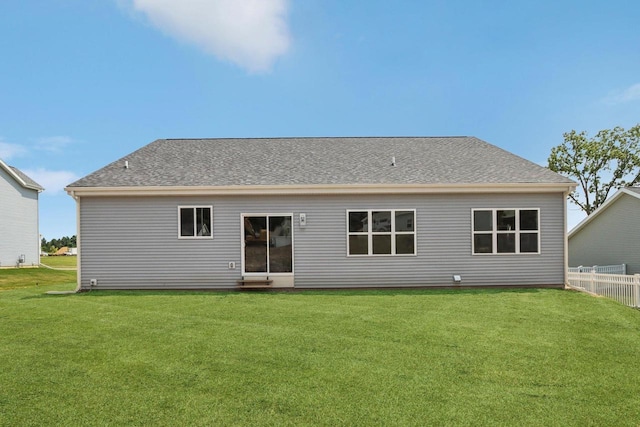 rear view of property with a yard