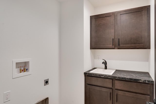 laundry area featuring cabinets, sink, hookup for a washing machine, and electric dryer hookup