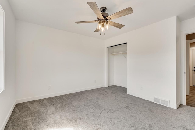 unfurnished bedroom with ceiling fan, a closet, and carpet flooring