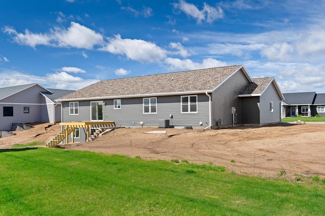 back of house with a lawn and central air condition unit