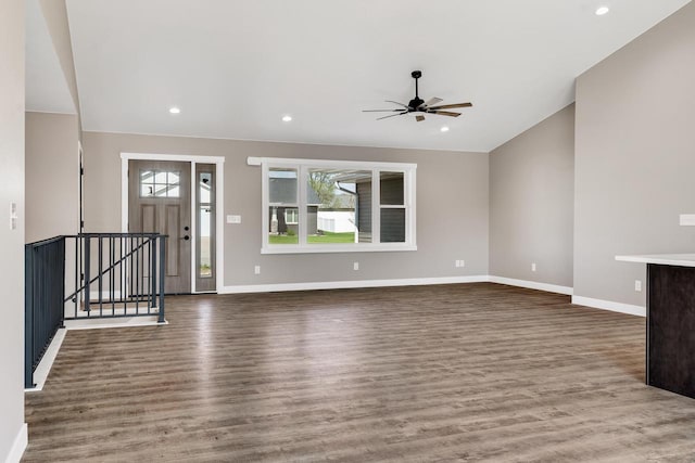 foyer with a wealth of natural light, wood-type flooring, ceiling fan, and lofted ceiling