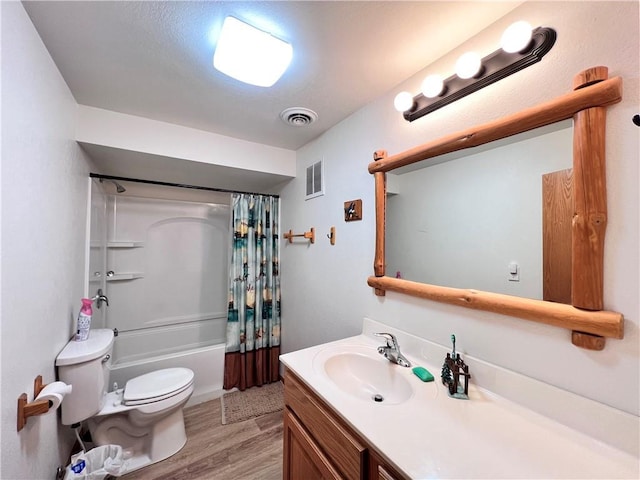 full bathroom featuring vanity, shower / bath combo with shower curtain, toilet, and wood-type flooring