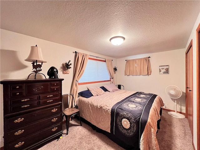 carpeted bedroom featuring a textured ceiling