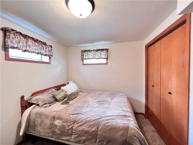 carpeted bedroom featuring a closet and a textured ceiling