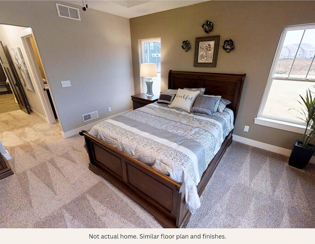 carpeted bedroom featuring multiple windows