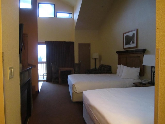 carpeted bedroom featuring high vaulted ceiling