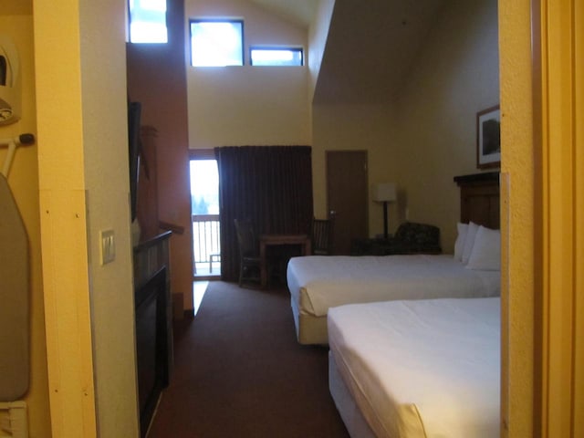 carpeted bedroom featuring high vaulted ceiling