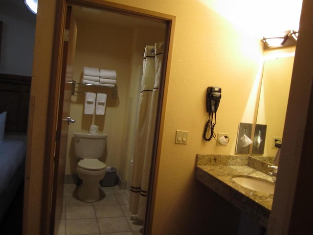 bathroom featuring tile patterned floors, sink, and toilet