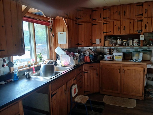 kitchen with sink, dark hardwood / wood-style flooring, and tasteful backsplash