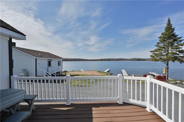 wooden deck featuring a water view