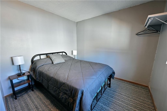 carpeted bedroom with a textured ceiling