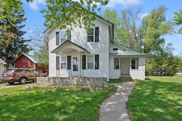 view of front of house featuring a front lawn and covered porch