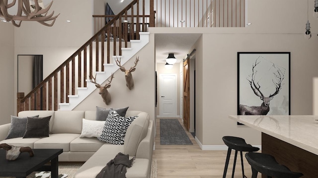 living room featuring a high ceiling and light hardwood / wood-style flooring