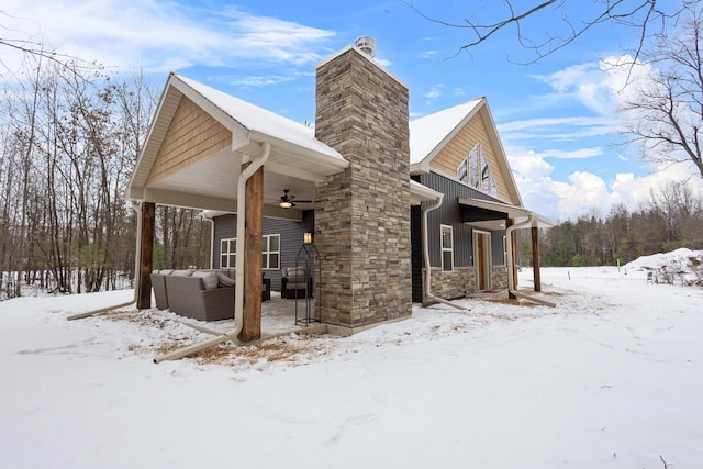 view of snowy exterior with ceiling fan