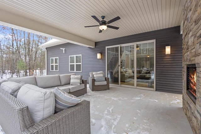 snow covered patio with ceiling fan and an outdoor hangout area