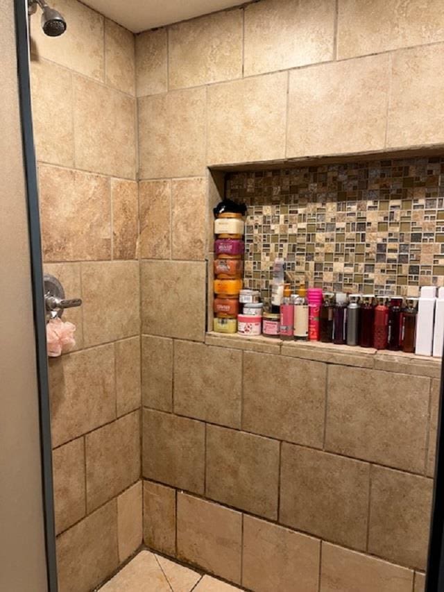 bathroom featuring tiled shower and tile flooring