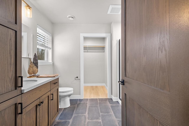 bathroom featuring vanity and toilet