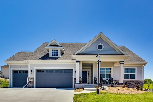 view of front of property featuring a porch and a garage