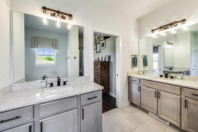 bathroom with dual vanity and tile flooring