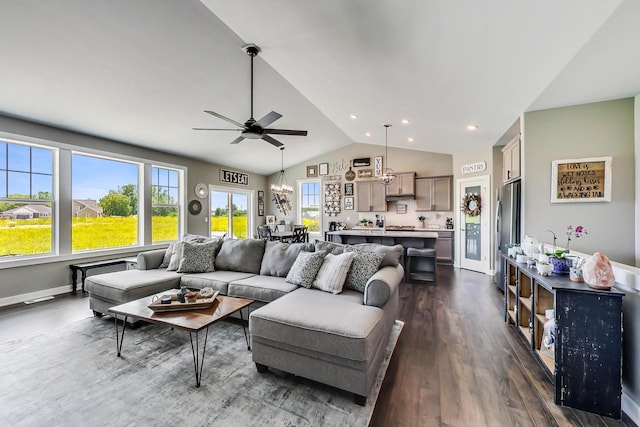 living room with ceiling fan, dark hardwood / wood-style flooring, and vaulted ceiling