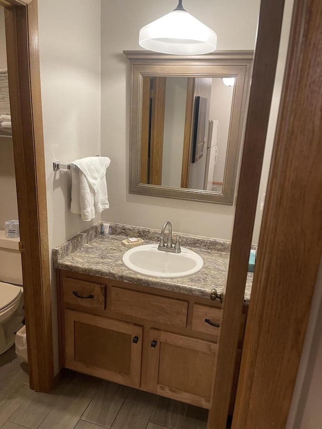 bathroom featuring vanity and toilet