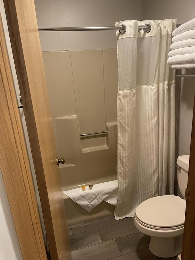 bathroom with hardwood / wood-style floors and toilet