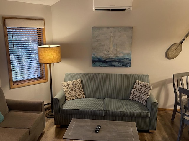 living room with a wall unit AC and hardwood / wood-style floors