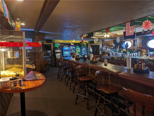 bar with ceiling fan and carpet flooring