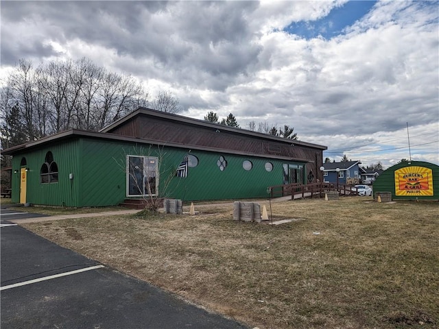 view of side of property with a lawn