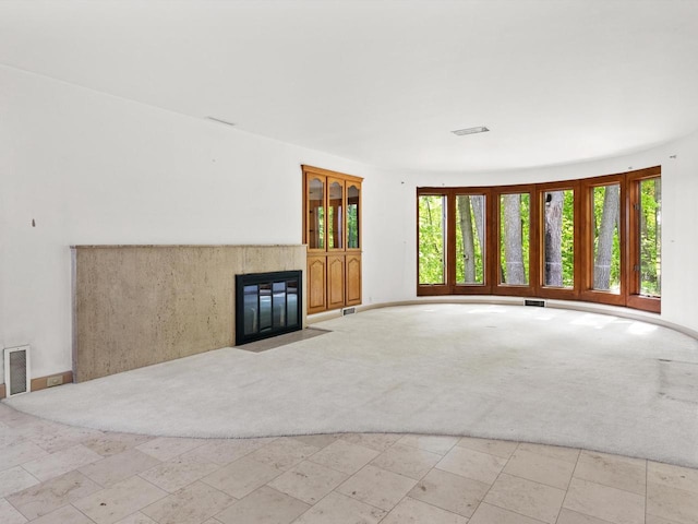 unfurnished living room with light colored carpet