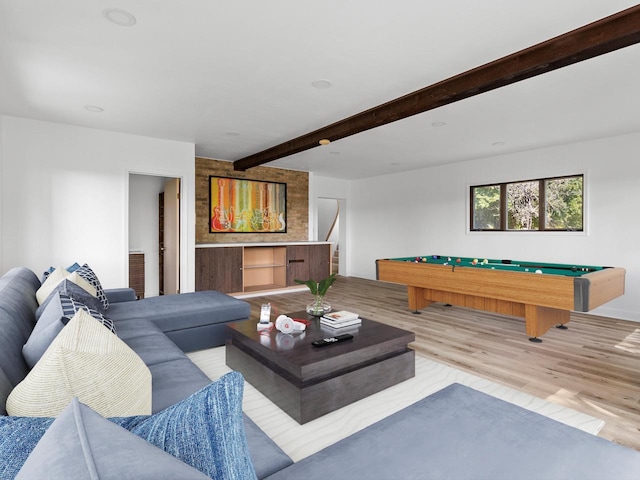 living room featuring beam ceiling, light wood-type flooring, and pool table