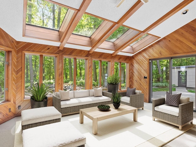 sunroom featuring vaulted ceiling with skylight