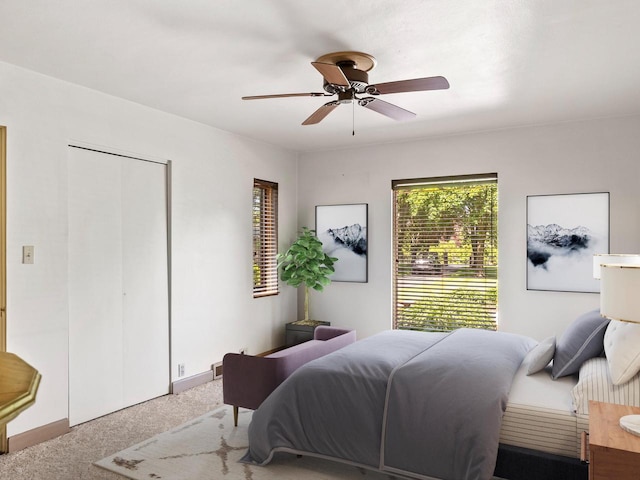 bedroom with ceiling fan, a closet, and carpet