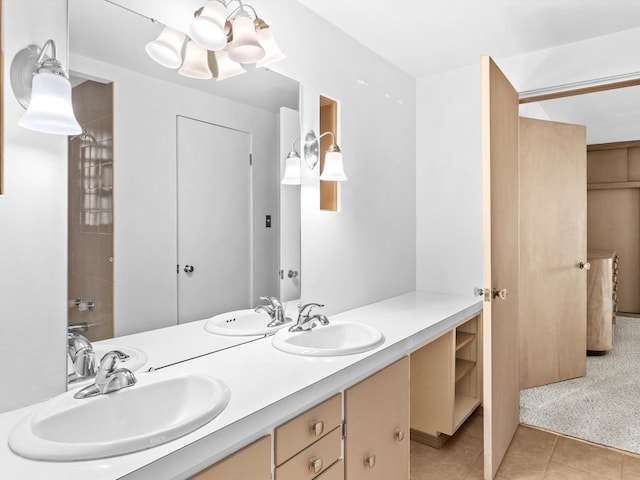 bathroom with tile patterned floors, vanity, and a notable chandelier