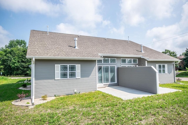 back of property with a lawn and a patio