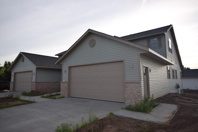 view of front of property with brick siding and an attached garage