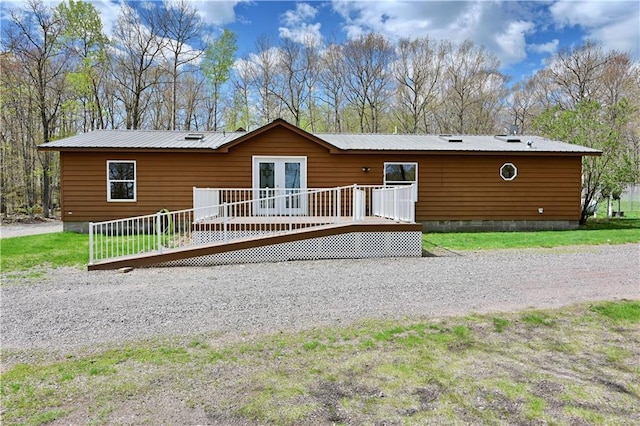 back of property featuring a wooden deck