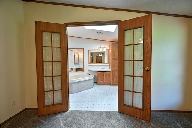 bathroom with crown molding, tile flooring, a tub, vanity, and lofted ceiling