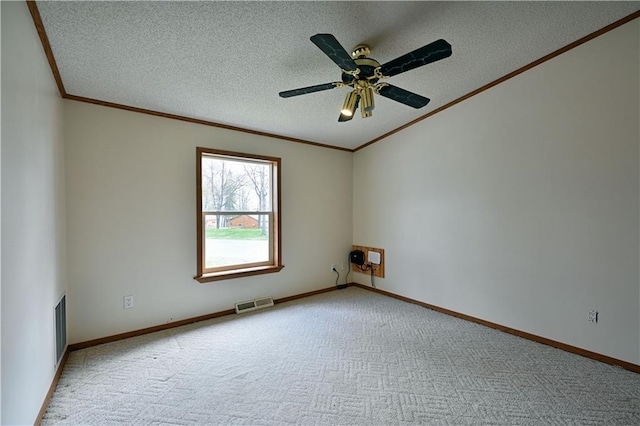 carpeted spare room with ceiling fan, a textured ceiling, and crown molding