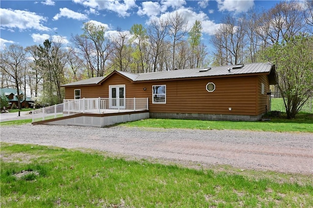 exterior space with a lawn and a wooden deck