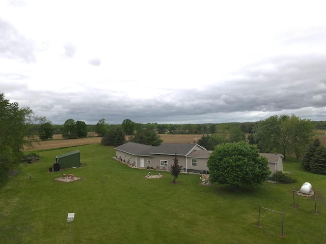 birds eye view of property with a rural view