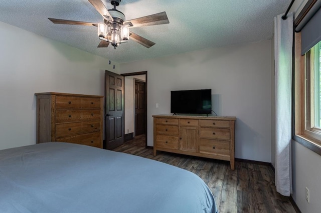 bedroom featuring ceiling fan, dark hardwood / wood-style floors, and a textured ceiling